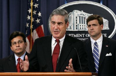 
FBI Director Robert S. Mueller, joined at left by Attorney General Alberto Gonzales, and Acting Assistant Attorney General of the Criminal Division John Richter, announces the indictments Wednesday of four men accused of planning a terror attack in the Los Angeles area. 
 (Associated Press / The Spokesman-Review)