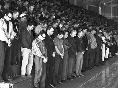 Students and faculty at Cal Poly bow their heads during a memorial service at the school gym.  (File Associated Press / The Spokesman-Review)
