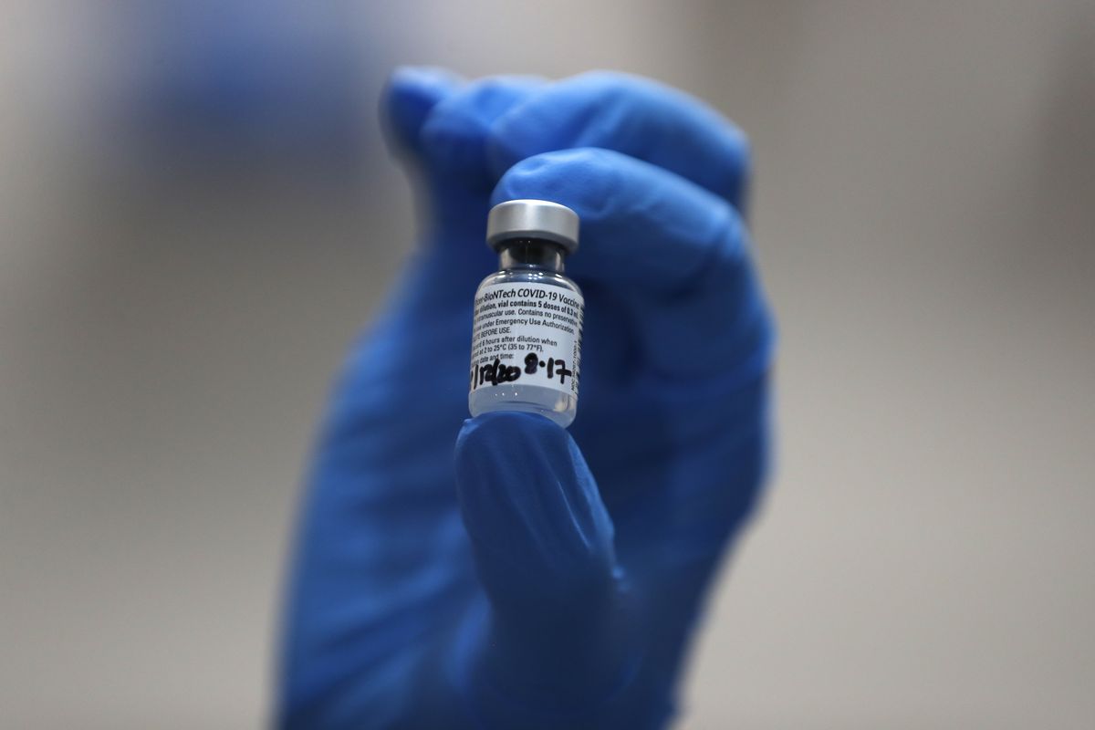 A nurse holds a phial of the Pfizer-BioNTech COVID-19 vaccine at Guy's Hospital in London, Tuesday, Dec. 8, 2020. U.K. health authorities rolled out the first doses of a widely tested and independently reviewed COVID-19 vaccine Tuesday, starting a global immunization program that is expected to gain momentum as more serums win approval.  (Frank Augstein)