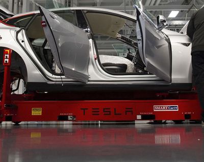 Tesla Motor Inc. employees work on the Model S electric car at the company's factory in Fremont, Calif.   (David Paul Morris/Bloomberg)