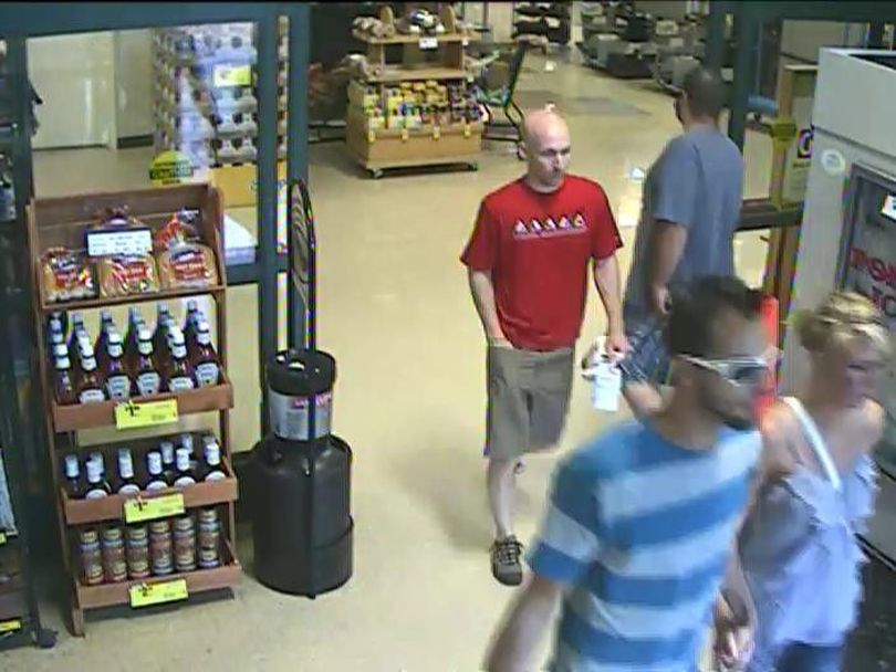 Spokane Valley Police are looking for help identifying the man in the red t-shirt, who is a suspect in a hit and run accident.  (Photo courtesy the Spokane Valley Police Department)