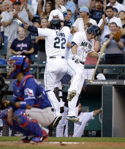 Seattle Mariners’ Robinson Cano celebrates his first-inning home run with Kyle Seager. Cano now has 12 home runs on season. (Associated Press)