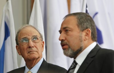 U.S. Middle East envoy George Mitchell, left, looks up as Israeli Foreign Minister Avigdor Lieberman talks to the press after their meeting in Jerusalem on Thursday. (Associated Press / The Spokesman-Review)