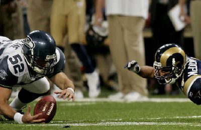 
Deep snapper J.P. Darch recovers the fumble by punt returner Shaun McDonald that preserves Seahawks win.
 (File/Associated Press / The Spokesman-Review)