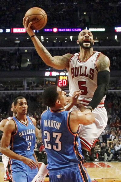 Bulls’ Carlos Boozer shoots over Thunder’s Kevin Martin. (Associated Press)