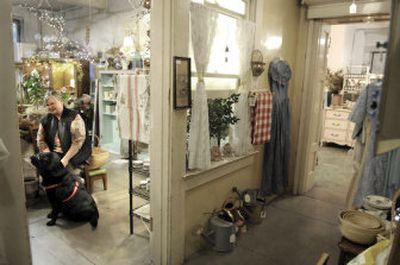 
Gloria Waggoner sits with her dog Madison last Thursday  at Rosa Gallica in Spokane. The  shop is in the basement of the Paulsen House, which also houses the Episcopal Diocese of Spokane headquarters. 
 (Photos by CHRISTOPHER ANDERSON / The Spokesman-Review)