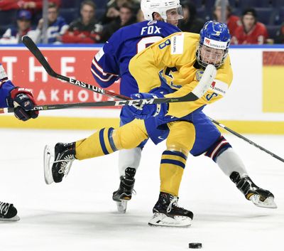 In this Jan. 4, 2018, file photo, Sweden’s Rasmus Dahlin (8) moves the puck around United States’ Adam Fox, rear, during the second period of a semifinal game at the world junior hockey championship in Buffalo, N.Y. With likelihood of selecting Dahlin with the first pick in the draft on Friday, June 22, the Buffalo Sabres are again in a position to end whats been a decade-long freefall. (Nathan Denette / Canadian Press via AP)