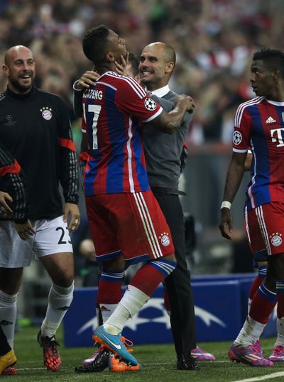 Jerome Boateng, center left, celebrates with Bayern coach Pep Guardiola after scoring in the 90th minute Wednesday. (Associated Press)