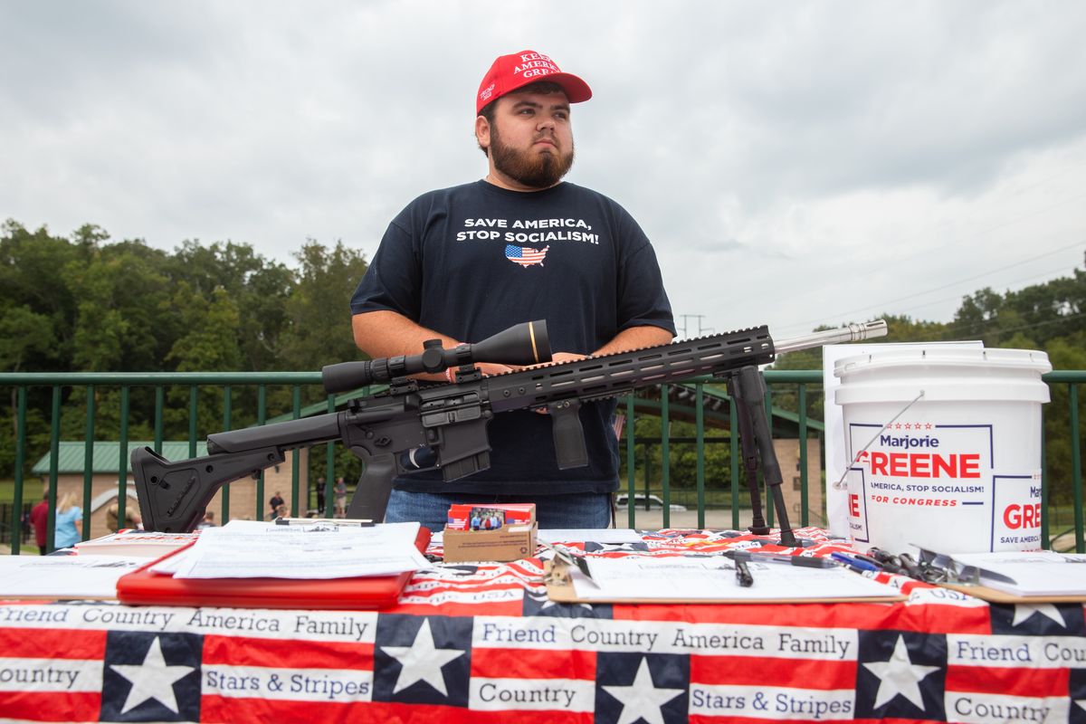 Brady Day, 18, works the raffle table for an AR-style rifle during a rally for Republican congressional candidate Marjorie Taylor Greene in Ringgold, Georgia, in September 2020. (Jessica Tezak/For the Washington Post)