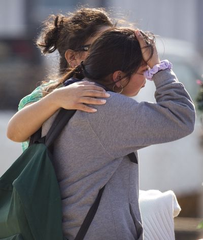 Ana Leal, left, tries to comfort Lone Star College student Sabrina Cuellar after she was evacuated from the campus following a shooting Tuesday. (Associated Press)