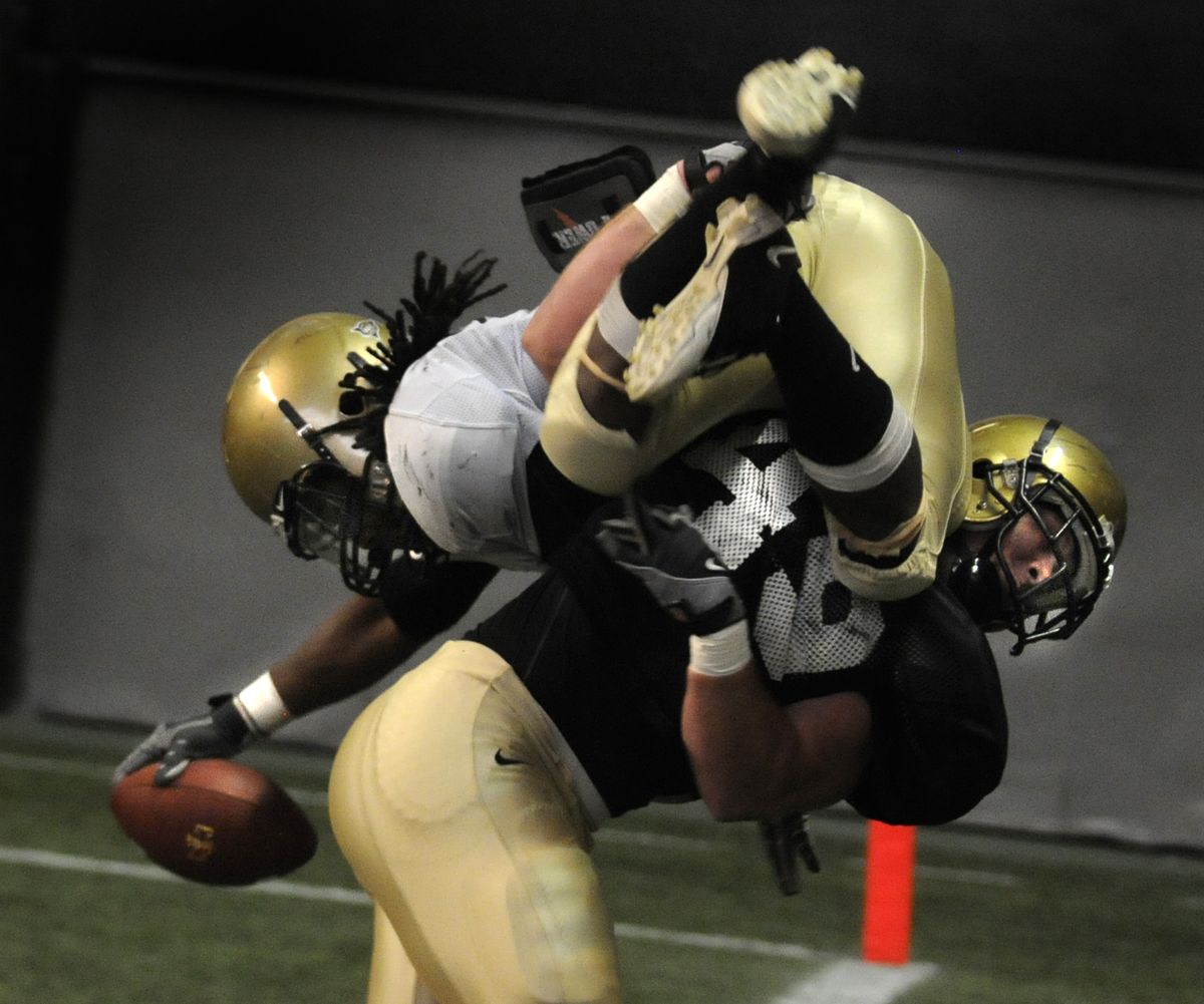 As running back Corey White dives for the end zone, he is stopped short by linebacker John McKinley. (Colin Mulvany)
