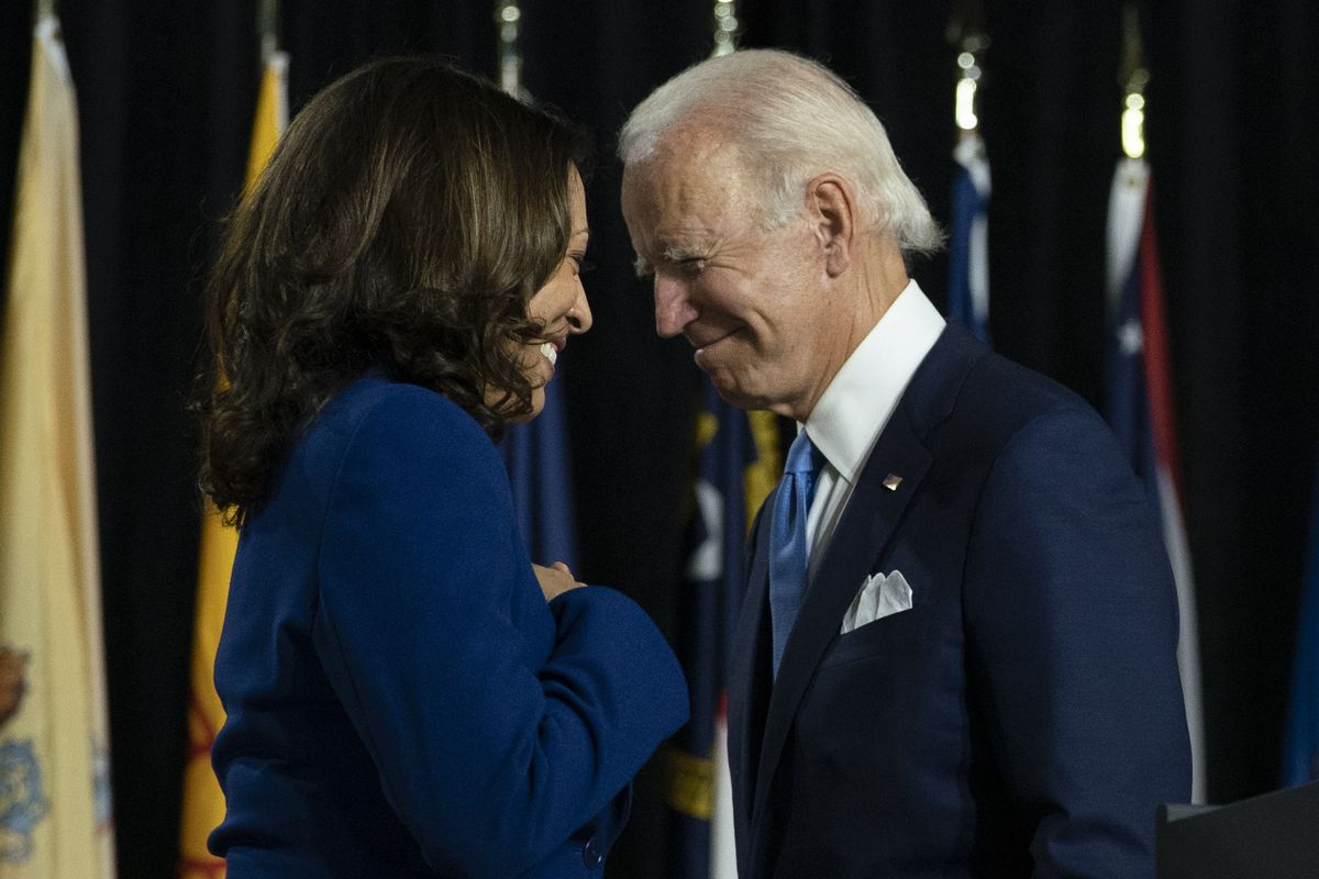 FILE - In this Aug. 12, 2020, file photo, Democratic presidential candidate former Vice President Joe Biden and his running mate Sen. Kamala Harris, D-Calif., pass each other as Harris moves to the podium to speak during a campaign event at Alexis Dupont High School in Wilmington, Del. Harris made history Saturday, Nov. 7, as the first Black woman elected as vice president of the United States, shattering barriers that have kept men — almost all of them white — entrenched at the highest levels of American politics for more than two centuries.  (Carolyn Kaster/Associated Press)