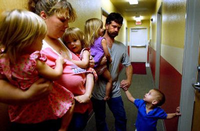 
Rindie Burgess and John King wait for the door to be unlocked to their apartment at St. Vincent de Paul's Transitional Housing Center in Coeur d'Alene recently with four of their children, from left, Nicole, 2, Natalie, 2, Savannah, 3, and Dylan, 3, after their 4-year-old son Austin locked them out. 
 (Kathy Plonka / The Spokesman-Review)