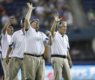 Seattle Seahawks coaches Dan Quinn, defensive line, left, and head coach, Pete Carroll, right, gesture on the sideline during an NFL preseason game against the Tennessee Titans in 2010. The scheme that carried the Seahawks to consecutive Super Bowls (2013-14) has become increasingly popular around the league. (John Froschauer / AP)