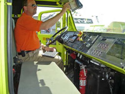 
Oshkosh Truck chief engineer John Beck programs a mission route Tuesday into TerraMax,  which can navigate traffic and avoid obstacles without a driver. Associated Press
 (Associated Press / The Spokesman-Review)