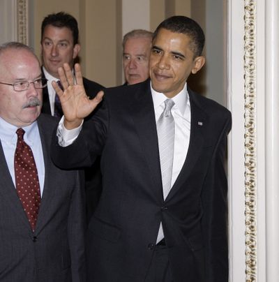 President Barack Obama walks into the Senate Democratic caucus Sunday.  (Associated Press)