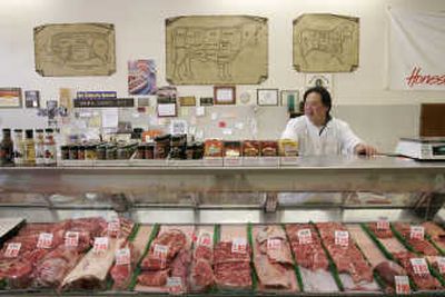 
Co-owner Mathew Lee awaits customers behind the counter at Save More Meats in Pacifica, Calif., on Monday.
 (The Spokesman-Review)