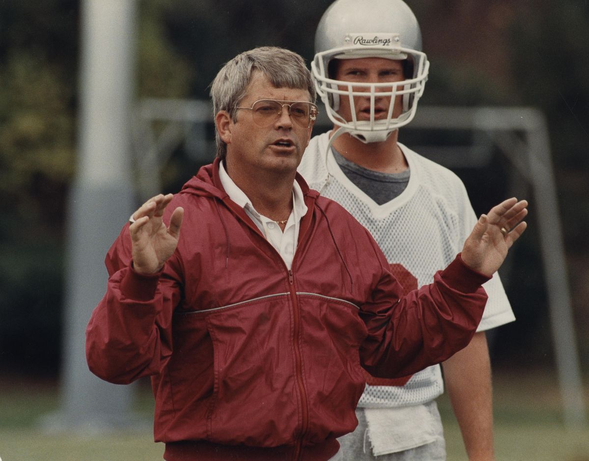 Washington State football coach Dennis Erickson with quarterback Timm Rosenbach at practice, 1988.