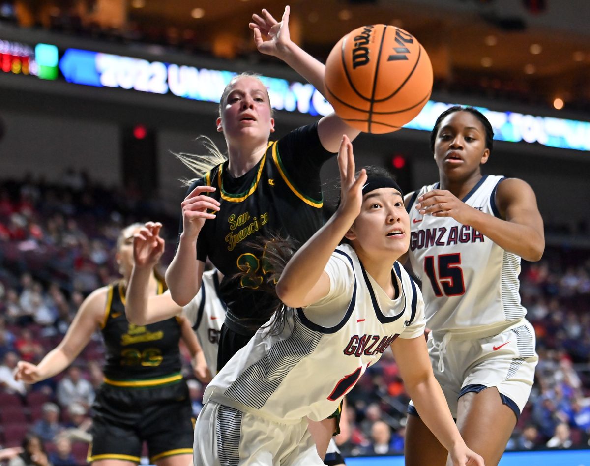 Gonzaga Bulldogs guard Kaylynne Truong (14) strains for a loose ball against San Francisco Dons forward Lucija Kostic (24) during the first half of the WCC Women’s Semifinal basketball game on Monday, Mar 7, 2022, in Las Vegas, Nev.  (Tyler Tjomsland/The Spokesman-Review)