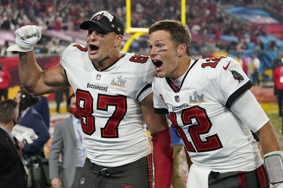 Tampa Bay Buccaneers tight end Rob Gronkowski, left, and quarterback Tom Brady celebrate after defeating the Kansas City Chiefs in the NFL Super Bowl 55 football game Sunday, Feb. 7, 2021, in Tampa, Fla. The Buccaneers defeated the Chiefs 31-9 to win the Super Bowl.  (Ashley Landis)