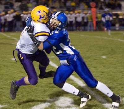 CdA’s Drew Turbin applies a hit to Lewiston’s John Rake during the second quarter. Special to  (BRUCE TWITCHELL Special to / The Spokesman-Review)