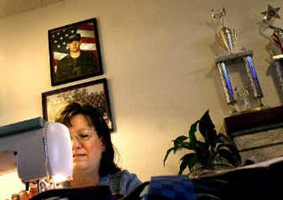 
Diana Kvalheim, of Spokane, settles into her daily routine of sewing as a photo of her son Leif, who has been deployed to Iraq, hangs overhead. 
 (Brian Plonka / The Spokesman-Review)