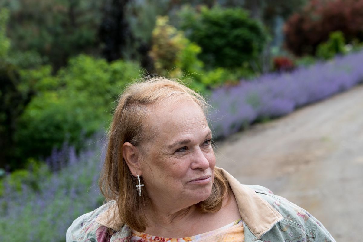 Anita Skinner poses for a photo in one of her gardens on Friday, June 1, 2018, at her home in Nine Mile Falls, Wash. (Tyler Tjomsland / The Spokesman-Review)