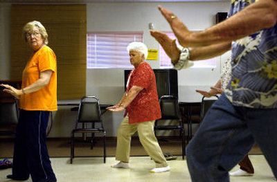 
Seniors practice the movements of tai chi at the Post Falls Senior Center with Bob Hughes. The free class is offered every Wednesday morning from 9-10. 
 (File/ / The Spokesman-Review)