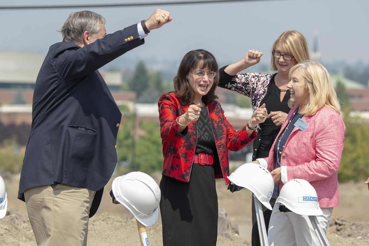 Eastern Washington University president . Mary Cullinan, center left, celebrates with members of her adminstration and the board of trustees Wednesday, Aug. 8, 2018, at the groundbreaking for the new Catalyst building in Spokane, which will combine some EWU programs with a tech business hub in a state-of-the-art building. It will make EWU a bigger player in the city’s University District. From left, board member James Murphy, Cullinan, board member Kim Pearman-Gillman and Mary Voves,  vice president for business and finance. (Jesse Tinsley / The Spokesman-Review)