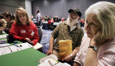 
Homeowners Grayce and John Coffman, center and right, meet with a lender as Connie Dertorossian, with the Fair Housing Council of Orange County, listens this month in Anaheim, Calif., during an event pairing homeowners facing foreclosure with lenders willing to restructure. Associated Press
 (Associated Press / The Spokesman-Review)