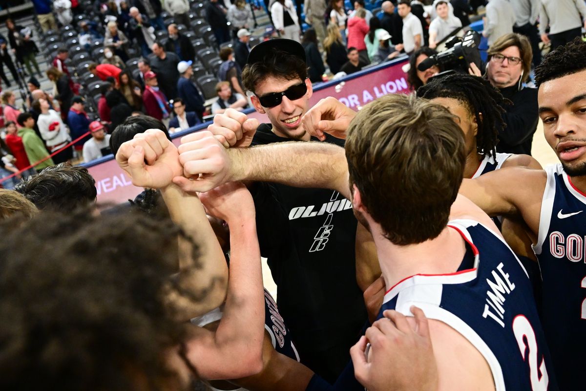 Chet Holmgren joins his former team in celebration after the Gonzaga Bulldogs defeated the Loyola Marymount Lions during the second half of a college basketball game on Thursday, Feb 162023, at Gersten Pavillian in Los Angeles, Calif. Gonzaga won the game 108-65.  (Tyler Tjomsland/The Spokesman-Review)