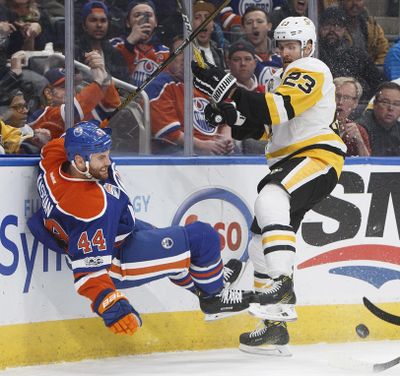Pittsburgh Penguins’ Scott Wilson (23) checks Edmonton Oilers’ Zack Kassian (44) during the third period of an NHL hockey game Friday, March 10, 2017, in Edmonton, Alberta. (JASON FRANSON / Associated Press)