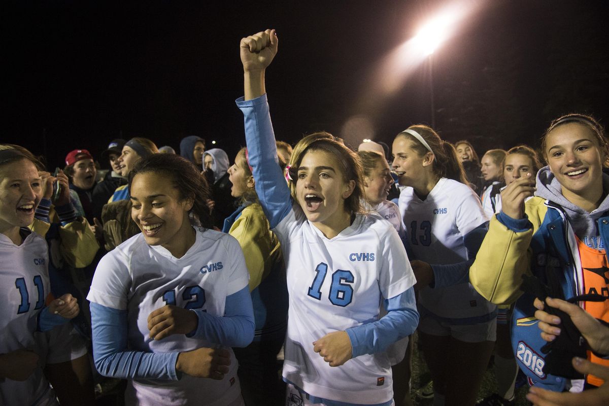 Central Valley forward Marissa Orrino (16) breaks the team huddle and celebrates the win over Sumner after their 4A state playoff game, Wednesday, Nov. 8, 2017, at SFCC. Madylyn Simmelink (11) and Alyssa Molina (12) join the fun at midfield. (Dan Pelle / The Spokesman-Review)