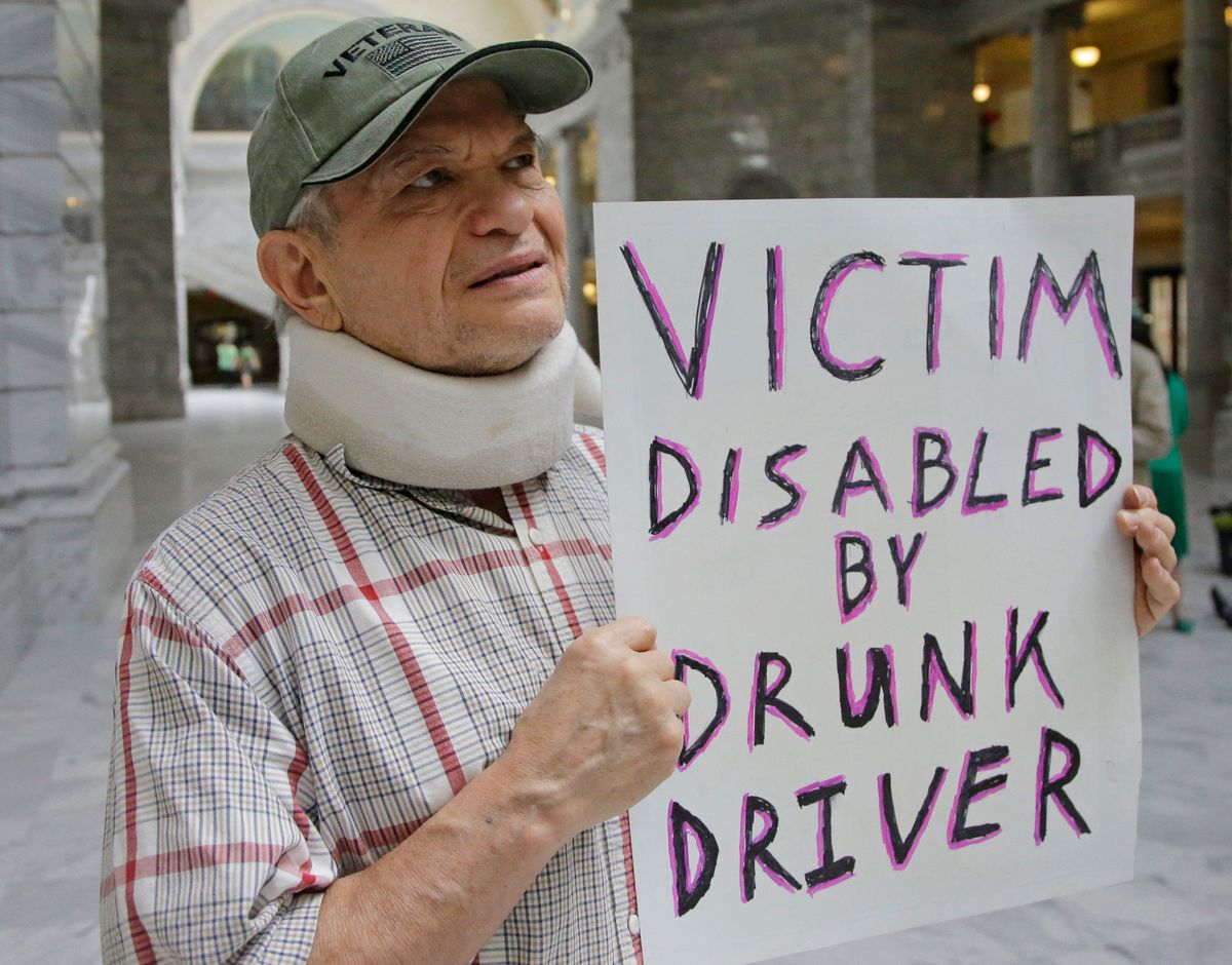 FILE — In this March 17, 2017, file photo, Ed Staley holds a sign during a rally at the Utah State Capitol in Salt Lake City. Car crashes and traffic deaths decreased in Utah the after state enacted the strictest drunken driving laws in the nation. A study published, Friday, Feb. 11, 2022, by the National Highway Traffic Safety Administration suggests Utah's roads became safer after the state lower the drunken driving threshold to .05% blood-alcohol content.  (Rick Bowmer)