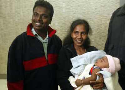 
Tsunami survivor Abilass Jeyarajah arrives at JFK international airport in New York on Tuesday with his parents, Murugupillai Jeyarajah and Jenita Jeyarahah. 
 (Associated Press / The Spokesman-Review)
