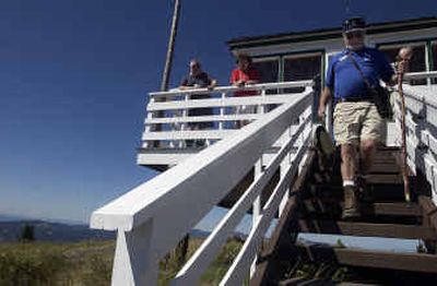 
Former fire lookouts Phil Ruff, right, and Rick and Naomi Barth help out at the historic fire lookout center on Kellogg Peak at Silver Mountain ski area. 
 (Jesse Tinsley / The Spokesman-Review)
