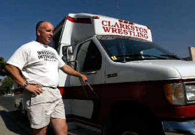 
Clarkston High wrestling coach Dan Randles stands with a donated bus that has been tailored specifically for the wrestling team but cannot be used because it does not meet the requirements for a school bus.
 (Kevin Nibur/ / The Spokesman-Review)