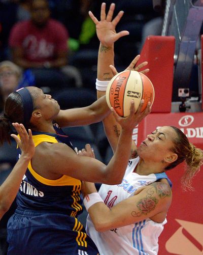 Indiana Fever’s Karima Christmas, left, charges hard at Atlanta Dream’s Erika de Souza under the basket in the second half. (Associated Press)