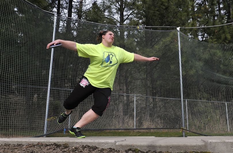 Junior Darbi Dobson, a thrower with the East Valley High School Knights track team, practices throwing the discus Monday during practice at EVHS. (Jesse Tinsley)