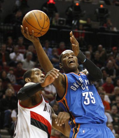 Oklahoma City’s Kevin Durant goes to the basket as Portland’s LaMarcus Aldridge defends. Portland won 103-95 Monday night. (Associated Press)
