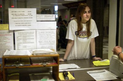 
University High student Katy Pinnock waits for her receipt after paying her fees for her ASB card and choir at the Business Office at University High in Spokane Valley on Monday. 
 (Liz Kishimoto / The Spokesman-Review)