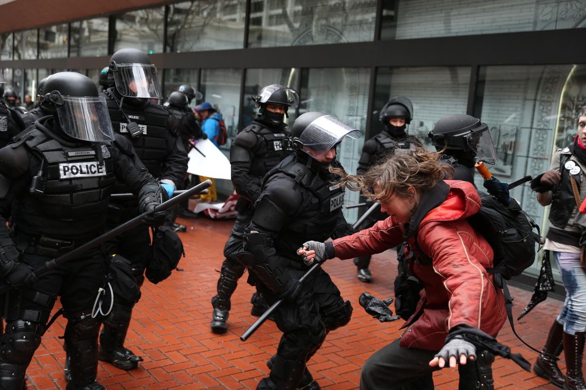 Protesters clash with police Monday, Feb. 20, 2017, in Portland, Ore. Thousands of demonstrators turned out Monday across the U.S. to challenge President Donald Trump in a Presidents Day protest dubbed Not My President