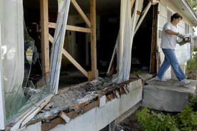 
Coeur d'Alene resident Laura Corbin  helps clean up  the home of the Rev. Roger LaChance after a pickup slammed into his Coeur d'Alene home Thursday morning. 
 (Kathy Plonka / The Spokesman-Review)