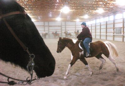 
Sunny Rae Yocom circles her horse around Trudy Brence's arena Jan. 4 in Bozeman. Winter cannot kill the enthusiasm of die-hard horseback riders, whether they are children or adults. 
 (Associated Press / The Spokesman-Review)
