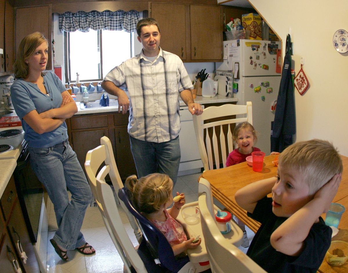 Mary and Chad Pugh supervise snack time at their kitchen table with their children Jack, 3, right, and Marian, 1, center, and their friend Eva Evans, 3, at their home in Watertown, Mass. Associated Press photos (Associated Press photos / The Spokesman-Review)