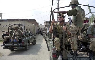Pakistan army troops patrol a troubled area of Damgar village after securing it from militants in Pakistan’s Swat district  Monday.  (Associated Press / The Spokesman-Review)