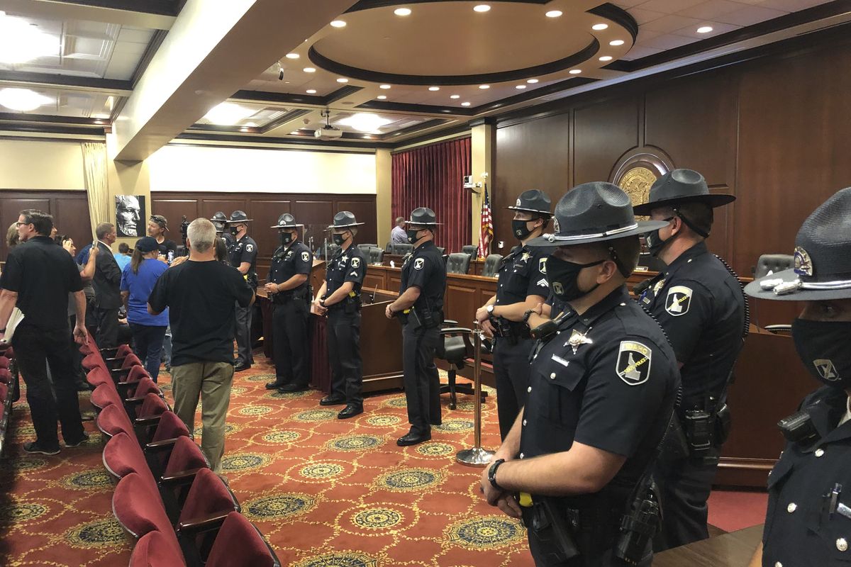 Idaho State Police form a shield Tuesday in a committee room in the Idaho Statehouse.  (Associated Press)