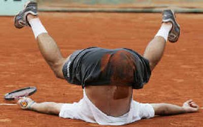 
Argentina's Jose Acasuso takes a tumble Thursday after upsetting American Andy Roddick in five sets. 
 (Associated Press / The Spokesman-Review)