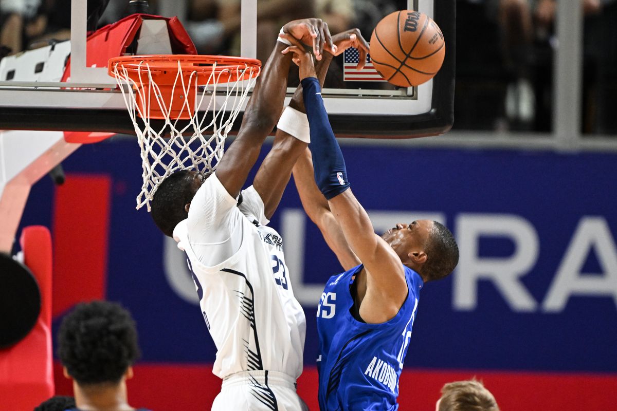 Grizzlies wing Cedric Coward blocks Mavericks center Kaodirichi Akobundu-Ehiogu on Monday in Las Vegas. (Tyler Tjomsland/The Spokesman-Review)