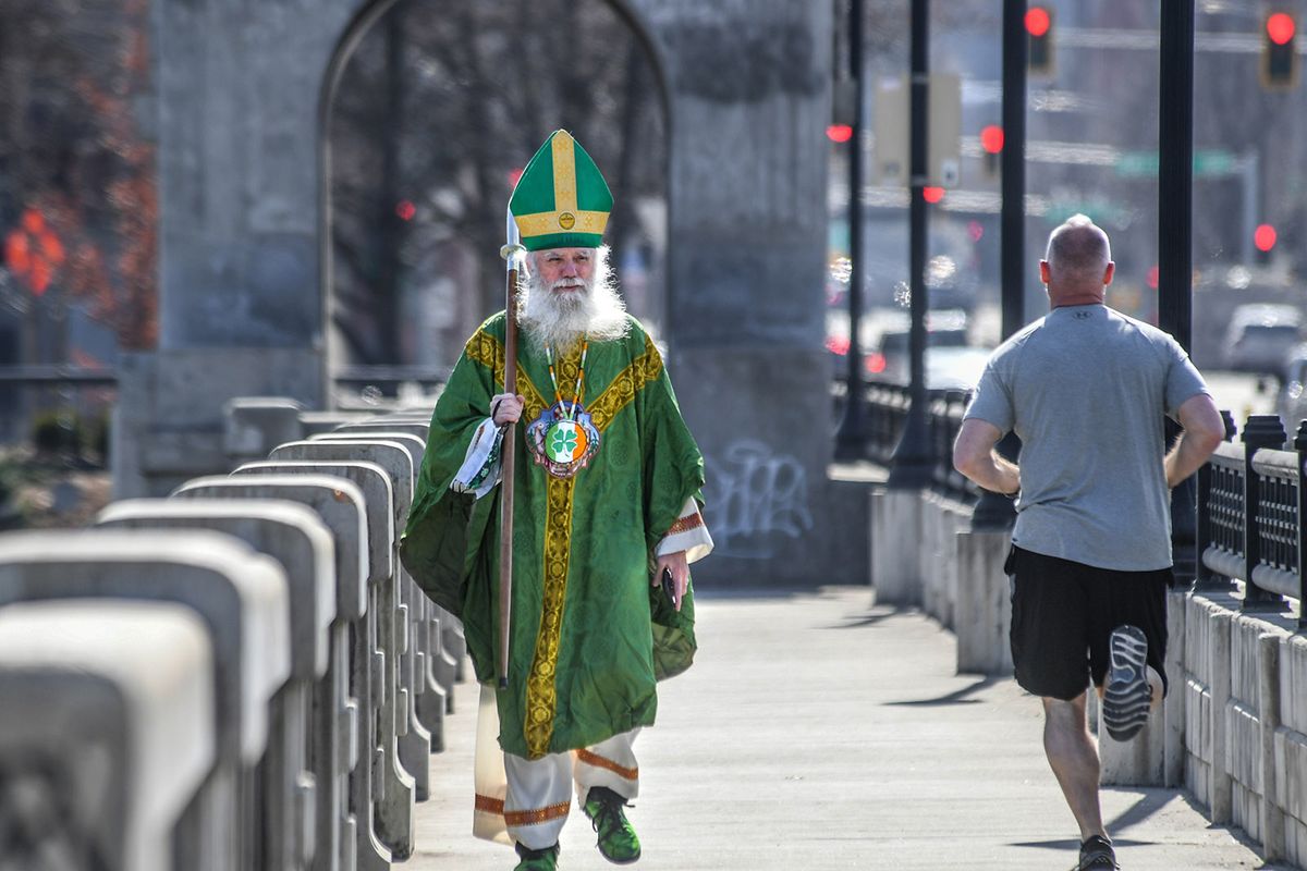 Tom Keefe, St. Patrick of Spokane, proceeds with his one-person parade across Monroe Street Bridge, Wednesday, March 17, 2021.  (DAN PELLE/THE SPOKESMAN-REVIEW)